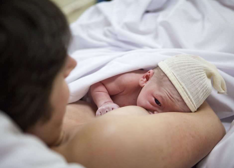 kobieta karmi piersią dziecko po urodzeniu w szpitalu